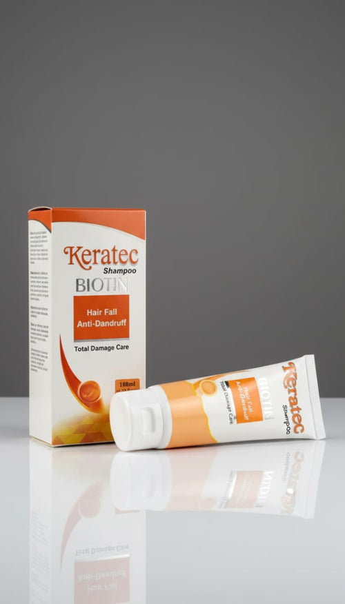 Kerat fee shampoo box and tube on a reflective surface with gray background
